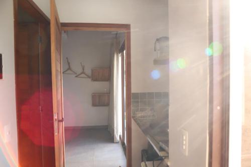 a hallway with a hallway leading into a room at Zero Meia Um Pousada in São Miguel do Gostoso