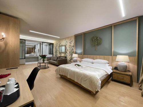 a bedroom with a large bed and a living room at VOTRE hotel in Jounieh