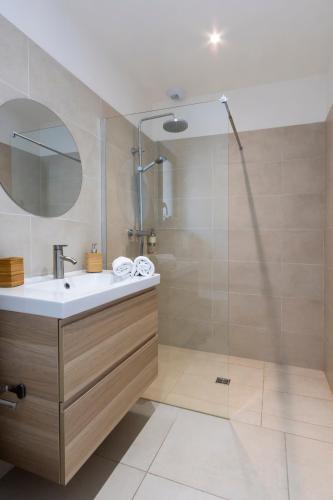 a bathroom with a sink and a shower at Casa Marina Cargèse in Cargèse