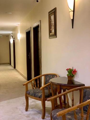 a room with a table and chairs and a table and a table and chairs at Ream Hotel Amman in Amman