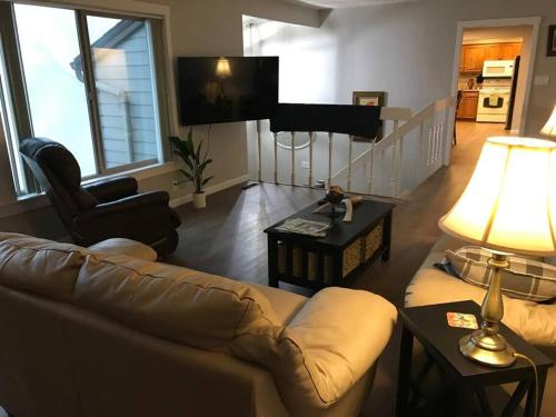 a living room with a couch and a table at Spectacular Valley View in Wine Country in Newberg