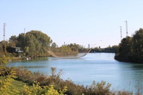 a river with a net in the water at Casa al Piave - appartamento a 5 km dal mare in Eraclea
