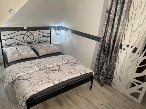 a bedroom with a bed with a black and white comforter at Willa Górska in Karpacz