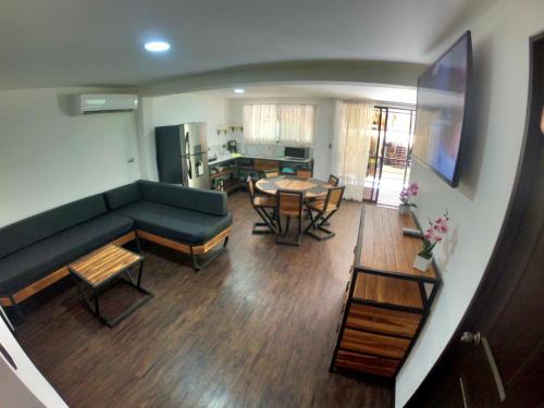 a living room with a couch and a table at Shark Town Mal Pais in Santa Teresa Beach