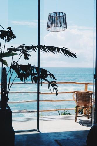 a window with a view of the ocean at Morena Boutique Hotel Weligama in Midigama