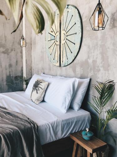 a bedroom with a large clock on the wall at Morena Boutique Hotel Weligama in Midigama