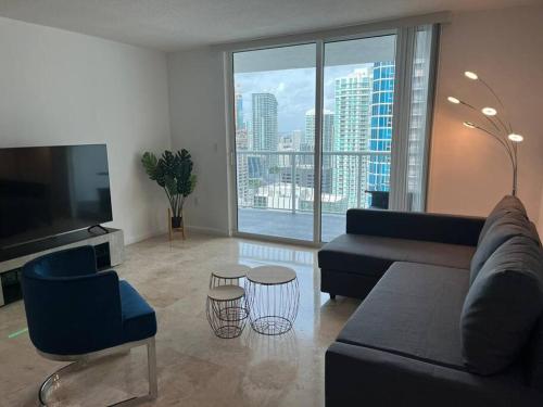 a living room with a couch and a large window at 1Bd Apt with Free Parking and Amazing View in Miami