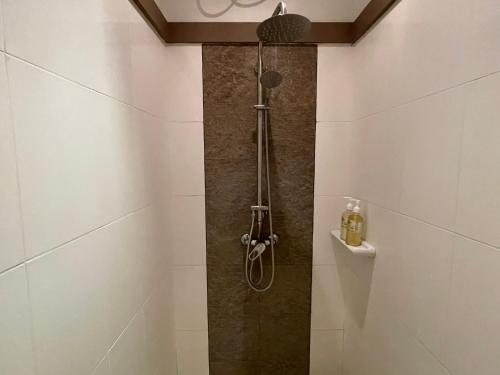 a shower in a bathroom with a glass door at The Pace Phuket Boutique Resort in Rawai Beach