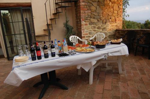 a table with bottles of wine and food on it at Podere Campovecchio in Rapale