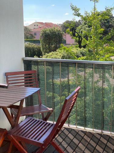 a pair of chairs and a table on a balcony at Villa CL in Vila do Conde