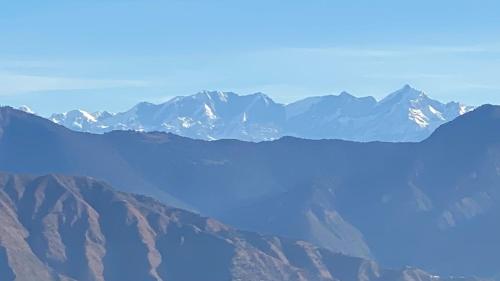 a view of a mountain range with blue water at Ananta Prana in Mussoorie