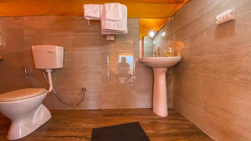 a bathroom with a toilet and a sink at Ananta Prana in Mussoorie
