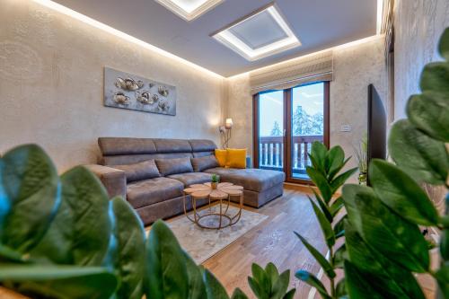 a living room with a couch and a table at Apartman Lux M&B in Zlatibor