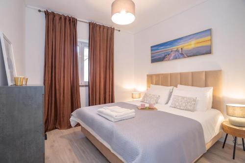 Ένα ή περισσότερα κρεβάτια σε δωμάτιο στο Happy Holiday Cascais