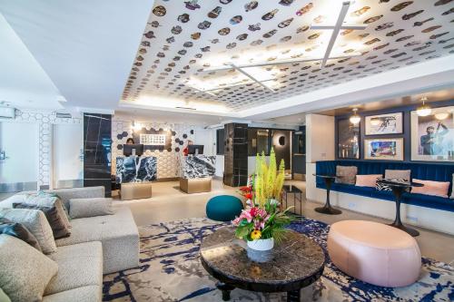 a living room with a couch and a table at Hotel Belmont Vancouver - MGallery Collection in Vancouver