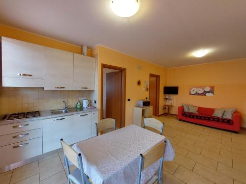 a kitchen with a table and a room with a couch at Agriturismo Il Melograno in Tessera