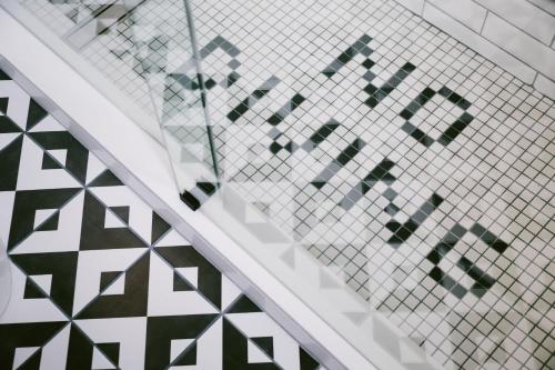 a stairwell with a patterned tile wall and a stair case at Hotel Belmont Vancouver MGallery in Vancouver