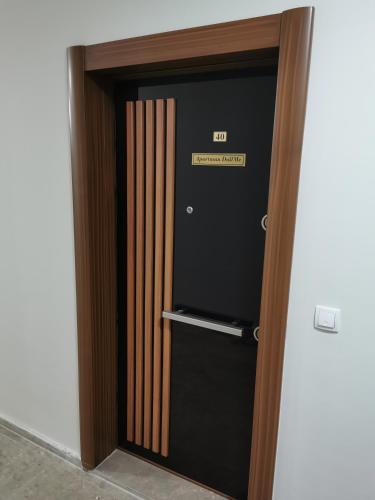 an elevator door with a sign that reads exit at Apartman DalMe in Novi Pazar