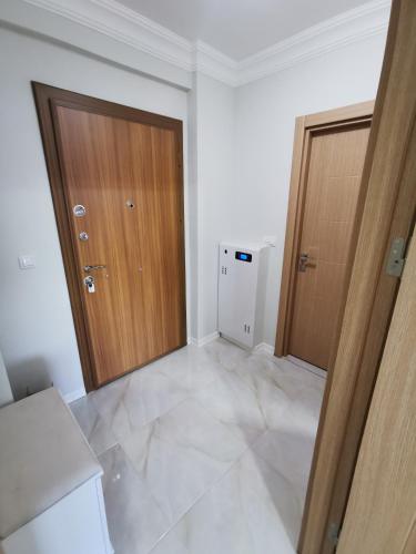 an empty room with two wooden doors in it at Apartman DalMe in Novi Pazar