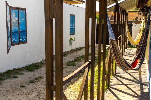 a porch with two hammocks in a house at Cabañas Puerto Surf in Mar del Plata