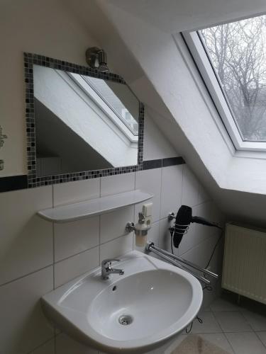 a bathroom with a sink and a mirror and a window at Rimvydas Apartment in Winterberg