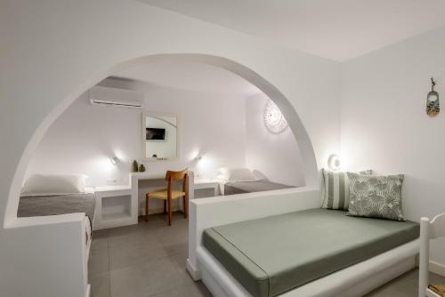 a bedroom with a bed and a desk in a room at Nissia Kamares in Kardamaina