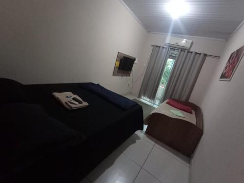 A bed or beds in a room at Casa Acomodação