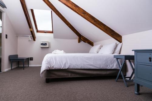 a bedroom with a bed and a desk and a window at Villa Viva Cape Town in Cape Town