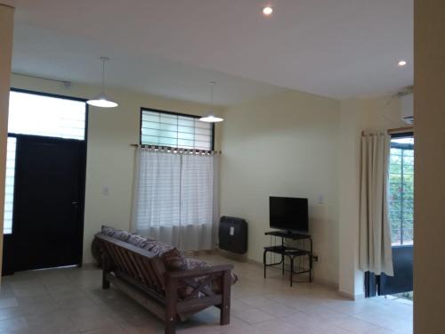 a living room with a couch and a television at Casa Huerta in Vista Flores