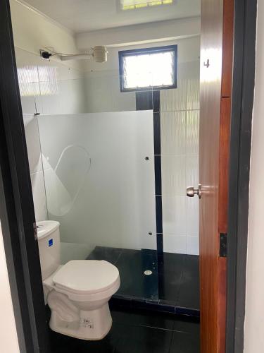 a bathroom with a toilet and a shower at BERAKHAH SPA & ROOMS in Guatapé