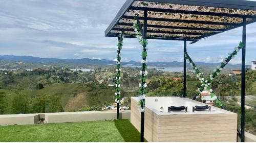 a hot tub sitting on top of a hill at BERAKHAH SPA & ROOMS in Guatapé