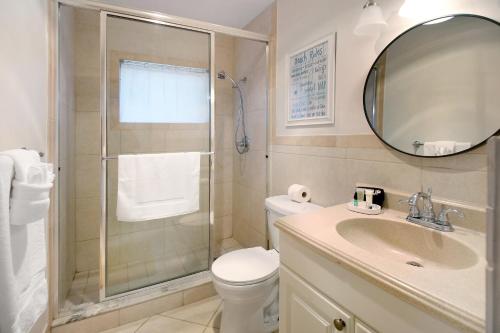 a bathroom with a shower and a toilet and a sink at The Waterman's Retreat- 3 bedroom waterfront unit in Fort Lauderdale
