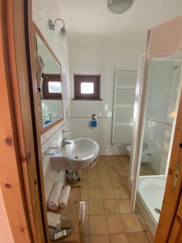 a bathroom with a sink and a shower and a tub at Principessa Giovanna Boutique Chalet in Roccaraso