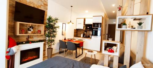 a living room with a kitchen and a dining room at SANS Lux Apartman N42 Milmari Kopaonik in Kopaonik