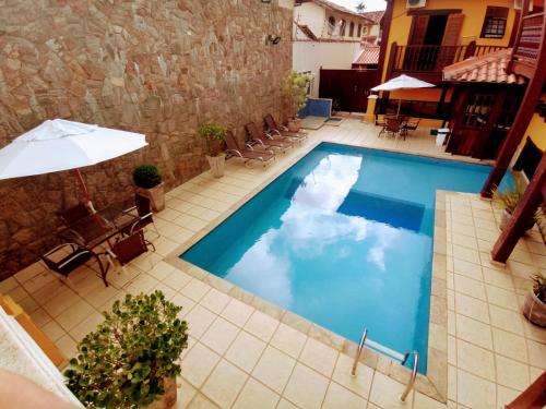 an image of a pool with clouds in the water at Aldeia Da Lagoinha in Ubatuba