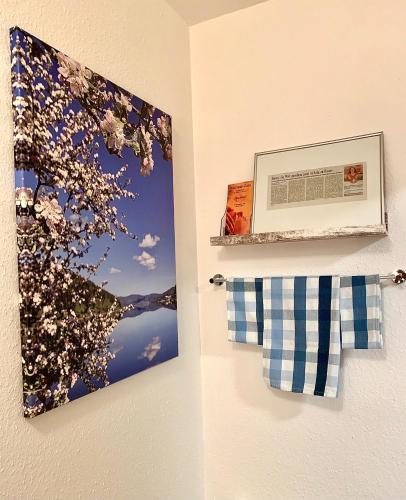 a picture of a tree with flowers on a wall at FeWo Fuchs Saig in Lenzkirch