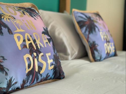 a purple pillow with the words panic ddos on a couch at Luxury Ocean view Condo @ Aruba’s Palm Beach in Palm-Eagle Beach
