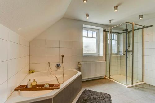 a large bathroom with a tub and a shower at Villa Meisen in Medebach