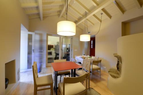 a dining room and living room with a table and chairs at Casa de Docim in Fafe