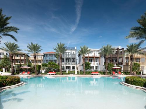 a large swimming pool with palm trees and apartments at Marlin Bay Resort & Marina Managed by Elite Alliance Hospitality in Marathon
