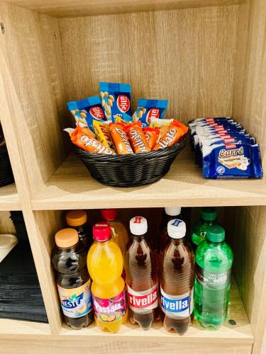 a shelf with drinks and a basket of snacks at Guesthouse Meitschi Thun - contactless self check-in in Thun
