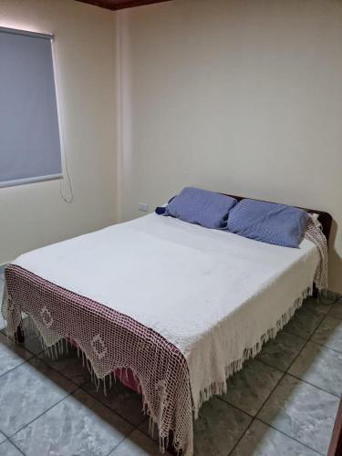 a bed in a white room with a window at ITURANCH in Ituzaingó