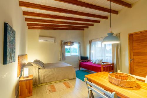 a bedroom with a bed and a table in a room at Alma Serena in La Paloma