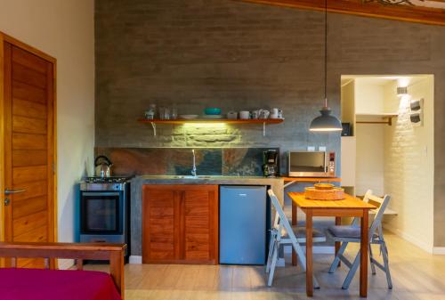 a kitchen with a table and a blue refrigerator at Alma Serena in La Paloma