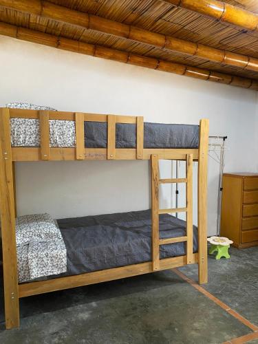 two bunk beds sitting in a room with a wall at Las Cabañas de Incahuasi in Lunahuaná