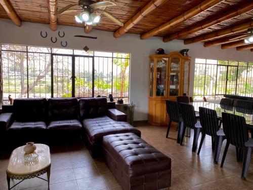 a living room with a couch and a table and chairs at Las Cabañas de Incahuasi in Lunahuaná