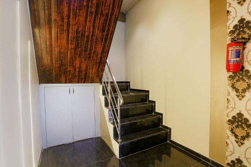 a hallway with a staircase with a wooden ceiling at FabHotel Prime Land - Nr BKC in Mumbai