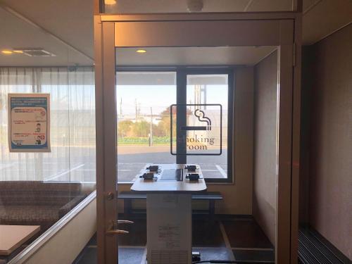 a door to a waiting room with a sign on the window at HOTEL COLLECT in Sakai