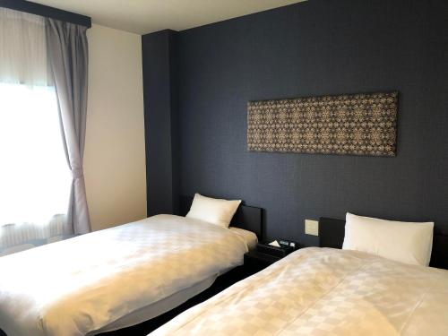 Ένα ή περισσότερα κρεβάτια σε δωμάτιο στο HOTEL COLLECT