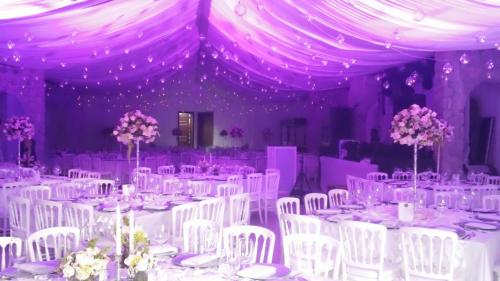 a room with white tables and white chairs and purple ceilings at Hotel Villa Monarca Inn in Zitácuaro